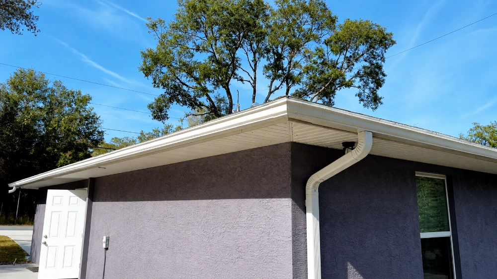 Gutter installation in Santa Barbara — seamless aluminum gutter fitted to a red-tile roofline